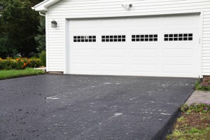 Rain Puddles on New Asphalt Driveway at Residential Home